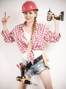 Girl using some power tools for work at home