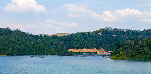 Mountain, lake and blue sky with white clouds