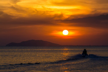 Orange sunset in Sanya, Hainan, China. Colorful madness from the clouds, merging with the sea.