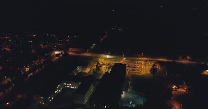 Aerial view of hospital at night. City landscape. Streets with cars at night.