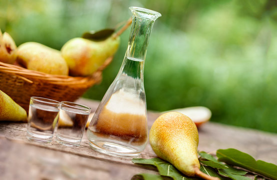 Pears and bottle with pear brandy