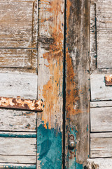 Green gray color mottled paint weathering cracked wooden door Close-up Vintage, Grungy, Old.