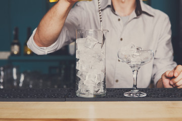 Bartender making ice for cocktail closeup