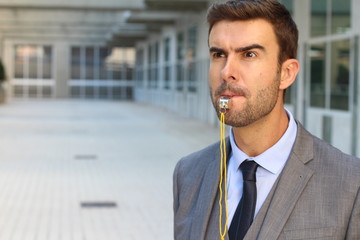 Businessman blowing a whistle isolated