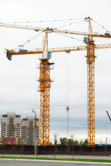 Large construction crane builds a house