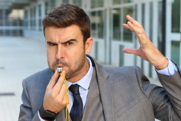 Businessman blowing a white isolated 