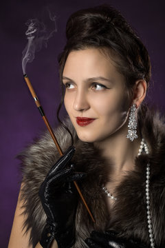beautiful female retro style portrait with cigarette on purple background