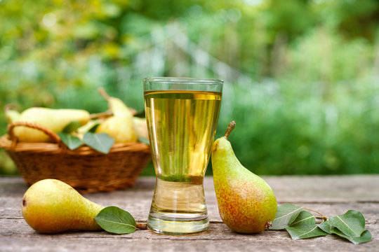 Glass with pear juice and pears
