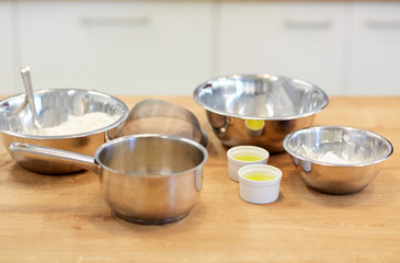 bowls with flour and egg whites at bakery kitchen