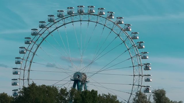 View Of The Attraction Ferris Wheel On Blue Sky Background
