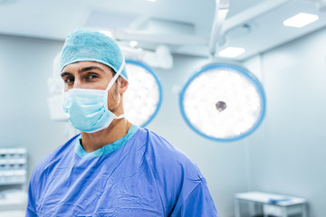 Medical professional wearing surgical mask and scrubs