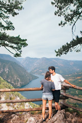 Fototapeta na wymiar Young tourists enjoying in view from top of a mountain