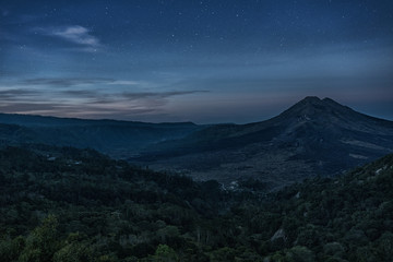 Fototapeta na wymiar Silhouette of the mountain volcano Batur on background night sky with stars