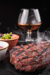 beef steak with a glass of cognac