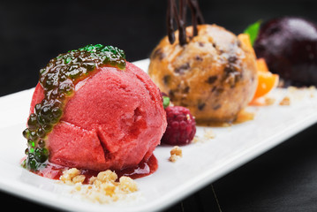 tasty ice cream with fruits on a white table
