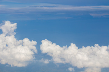 Naklejka na ściany i meble Sky, clouds and ground taken from the window of the plane.