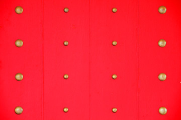tradition chinese door with brass knot on red wooden panel background