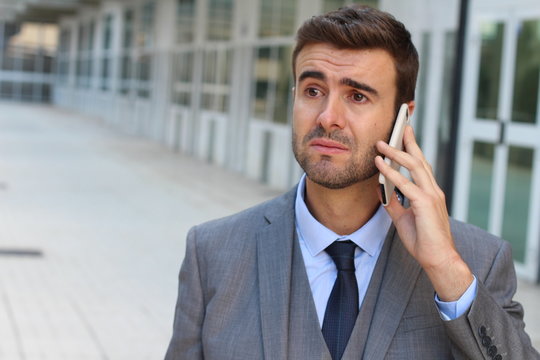 Businessman crying on the phone