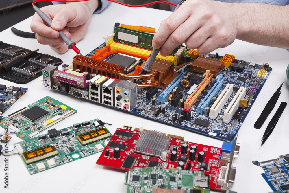 Poster engineer checking motherboard with multimeter