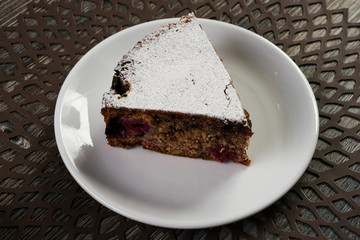 Slice of homemade cranberry pie cake with walnuts