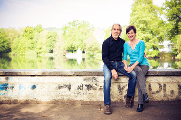 Senior Couple Relaxing By The Lake