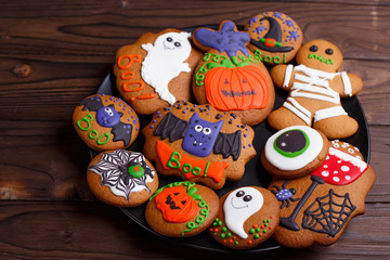 Composition of fresh homemade halloween gingerbread cookies on the plate, close up