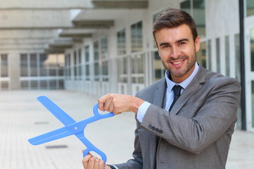Businessman holding a pair of scissors
