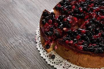 Delicious homemade mascarpone cheese cake with blackberry and winter berries. Vegetarian Cheesecake cake on wooden background with copy space, top view. Christmas dessert. Healthy food