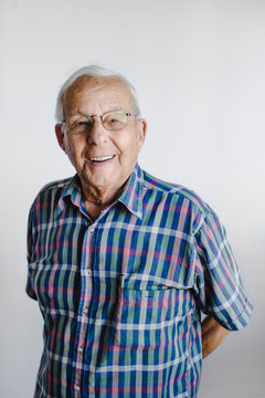 Happy senior man looking at camera on white background