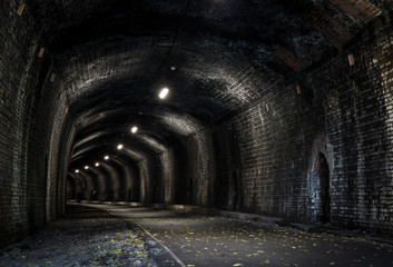 View into a dark old railway tunnel
