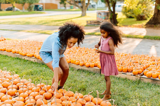 Mother and daughter in pumpkin patch