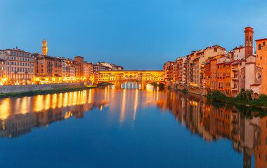 Panorama of River Arno and famous bridge Ponte Vecchio at night from Ponte Santa Trinita in Florence, Tuscany, Italy