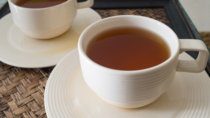 White cup of hot tea on vintage table. Healthy tea time.
