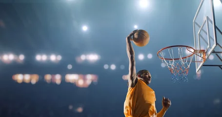Fotobehang Basketbalspeler voert een slam dunk uit op een sportachtergrond © haizon
