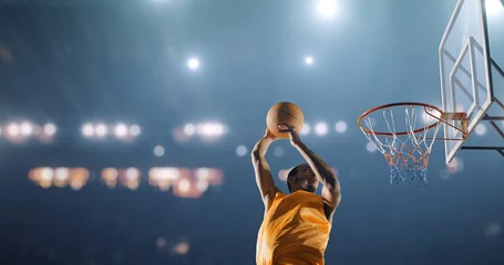 Fotobehang Basketbalspeler voert een slam dunk uit op een sportachtergrond © haizon