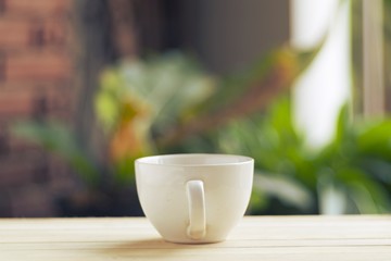 White coffee cup on wooden floor