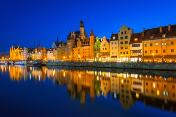 Old town of Gdansk at night reflected in Motlawa river, Poland