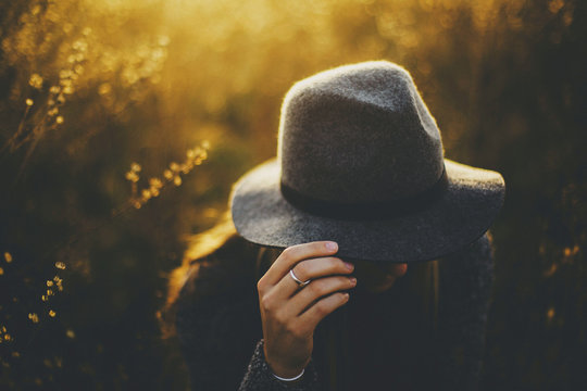 Young Woman Hides Face Under Hat