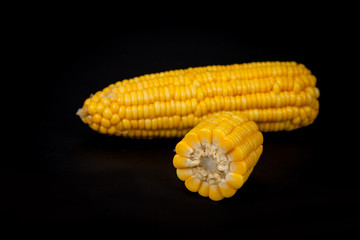 yellow fresh corn on black background