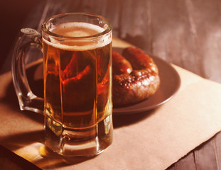 Beer in a glass on wooden background. Beer and beer snack.
