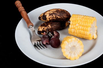 Food waste ,apple ,banana,corn and grape fruit with fork on dish