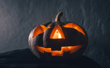 halloween pumpkin head with candle light in darkness background