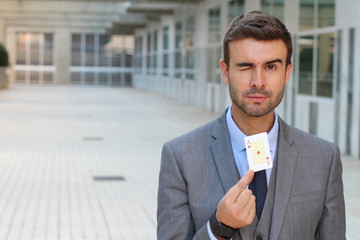 Businessman showing the ace of hearts