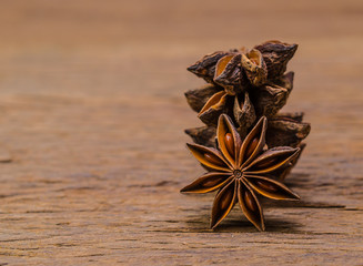 Star anise on wooden board background