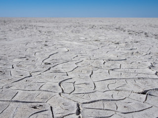 Cracked grey and white soil of giant dry salt flat or salt pan in Botswana, Southern Africa