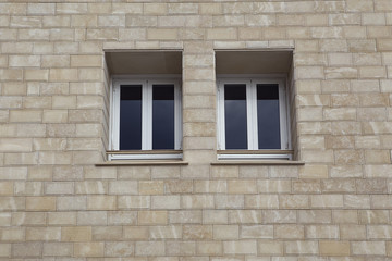 Fototapeta na wymiar Paired windows in a brick building. Limassol. Cyprus.