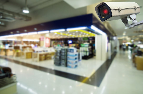 CCTV security indoor camera system operating with blurred image in supermarket or shopping mall, surveillance security and safety technology concept