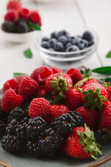 Mixed berries in glass bowls closeup, selective focus