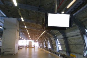 LCD TV with white blank screen or billboard, copy space for your text message, advertising or media and content in sky train station or airport, commercial, marketing and advertising concept