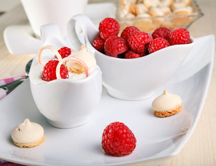 Bisquits and raspberry served with yogurt on dessert.